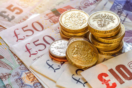 132712986-british-coins-stack-on-black-pound-sterling-business-concept.jpg